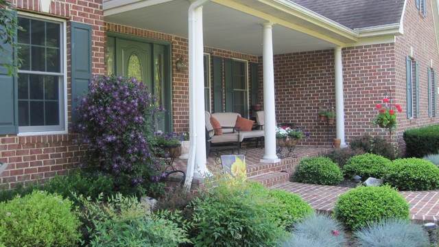 brick front porch with colorful landscape