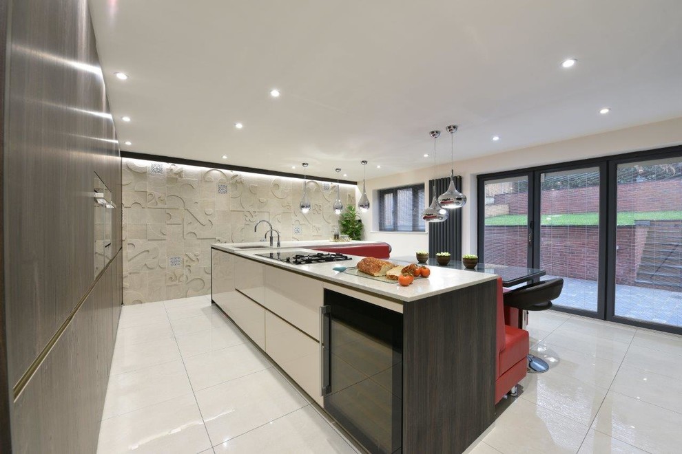 Contemporary galley open plan kitchen in Manchester with an undermount sink, flat-panel cabinets, dark wood cabinets, solid surface benchtops, stainless steel appliances, porcelain floors and with island.