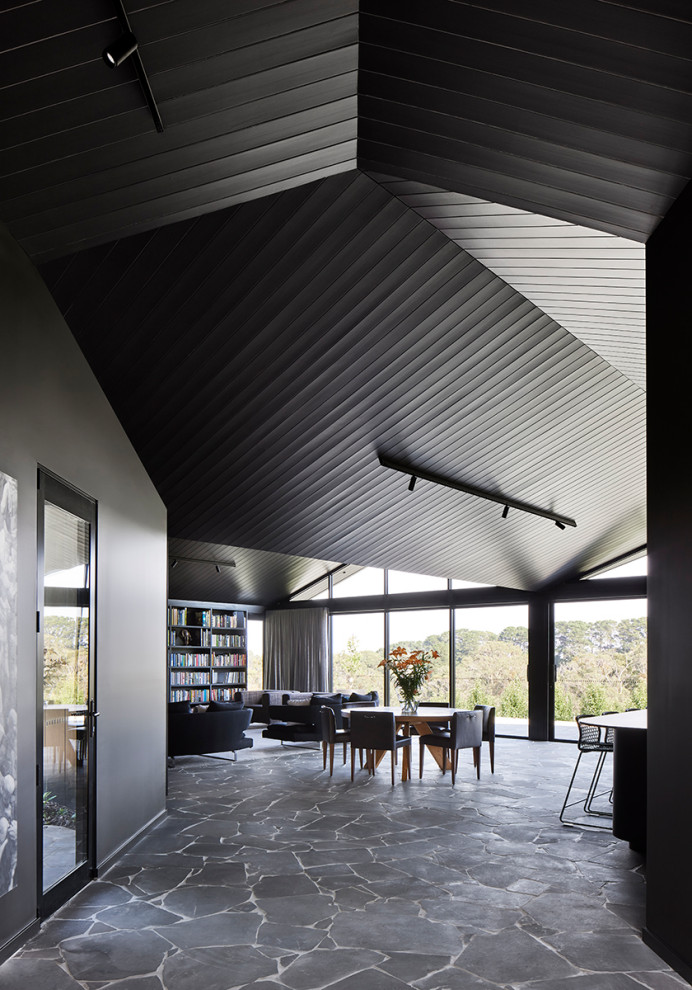 Inspiration for a large contemporary vaulted ceiling family room remodel with black walls
