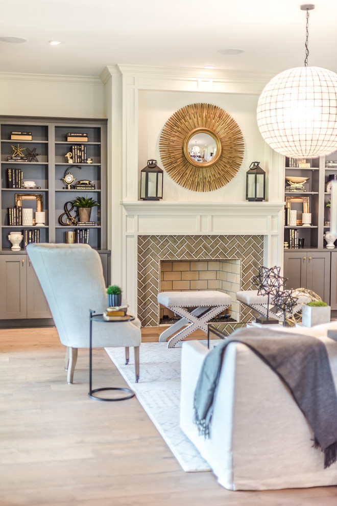 Inspiration for a transitional family room in Jacksonville with white walls, medium hardwood floors, a standard fireplace and a tile fireplace surround.