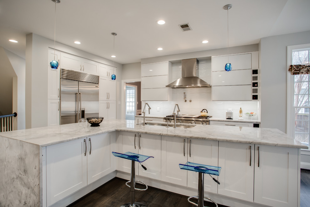 Inspiration for a large transitional single-wall eat-in kitchen in DC Metro with an undermount sink, recessed-panel cabinets, white cabinets, marble benchtops, white splashback, ceramic splashback, stainless steel appliances, dark hardwood floors and with island.