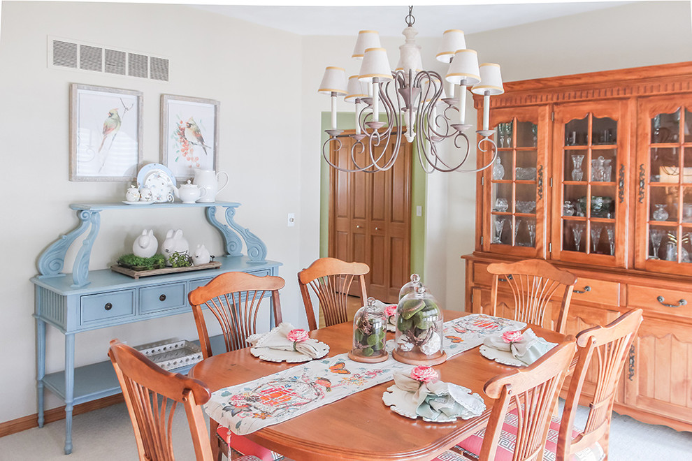 This is an example of a mid-sized tropical open plan dining in St Louis with beige walls, carpet and beige floor.