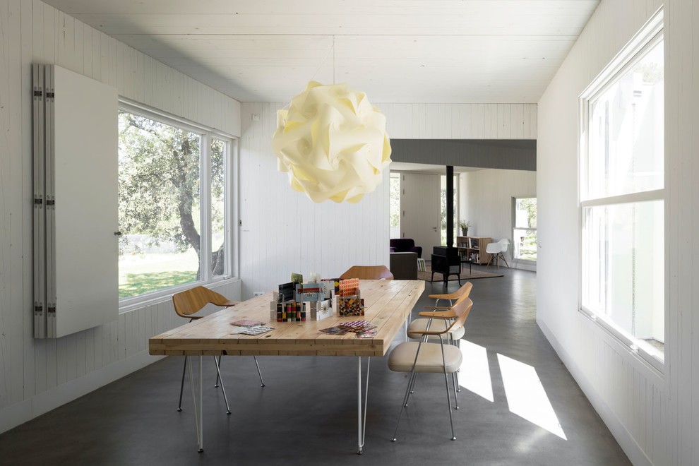 Inspiration for a large contemporary open plan dining in Madrid with white walls, concrete floors and no fireplace.
