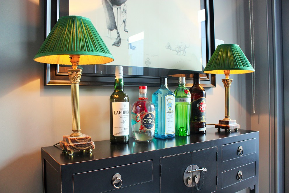 Inspiration for a small eclectic single-wall home bar in Kent with black cabinets, wood benchtops and black benchtop.