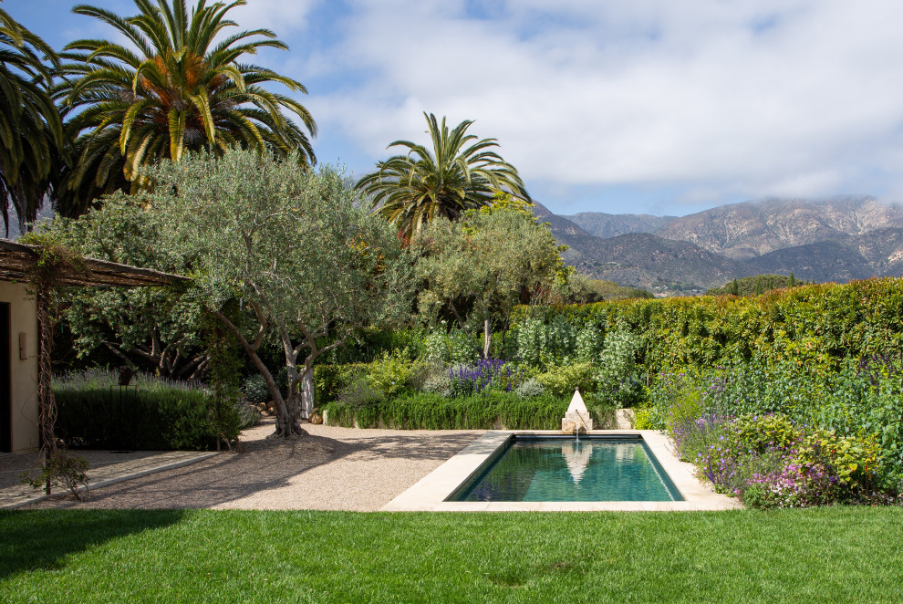 Photo of a mid-sized mediterranean backyard rectangular pool in Santa Barbara with with a pool and natural stone pavers.
