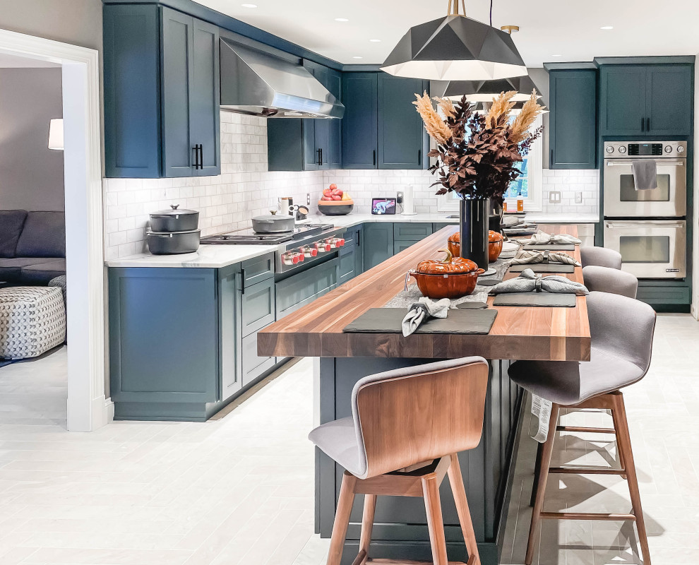 Example of a large minimalist l-shaped porcelain tile and gray floor eat-in kitchen design in Baltimore with an undermount sink, shaker cabinets, blue cabinets, quartzite countertops, white backsplash, subway tile backsplash, stainless steel appliances, an island and white countertops