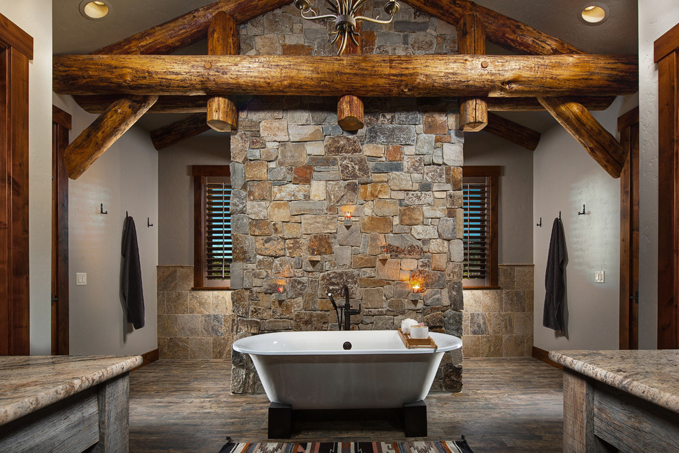 This is an example of a large country master bathroom in Other with flat-panel cabinets, distressed cabinets, a freestanding tub, an open shower, a two-piece toilet, grey walls, dark hardwood floors, a vessel sink and granite benchtops.