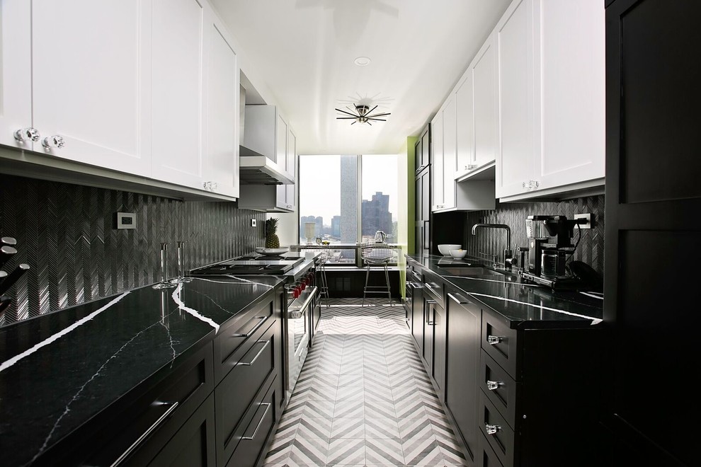 Photo of a contemporary galley separate kitchen in New York with an undermount sink, shaker cabinets, black splashback, stainless steel appliances and multi-coloured floor.