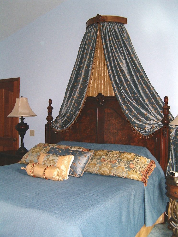 Large traditional master bedroom in Other with blue walls, carpet and blue floor.