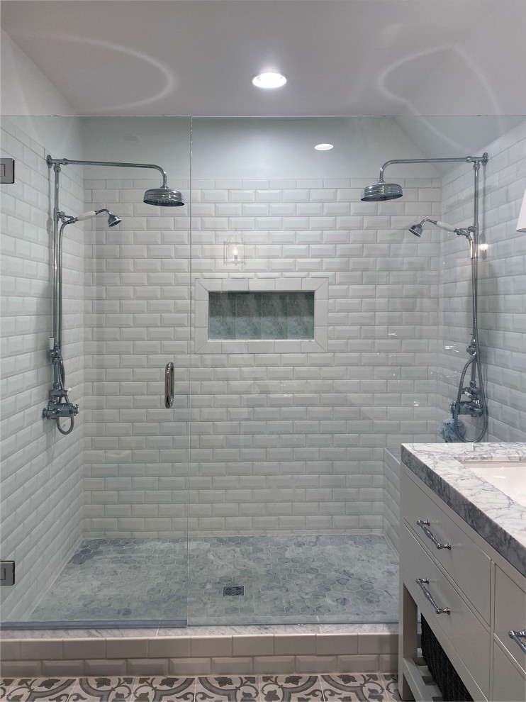 This is an example of a large transitional master bathroom in Nashville with recessed-panel cabinets, white cabinets, a claw-foot tub, a double shower, an urinal, white walls, porcelain floors, an undermount sink, marble benchtops, a hinged shower door, grey benchtops, an enclosed toilet, a double vanity, a freestanding vanity, vaulted and planked wall panelling.