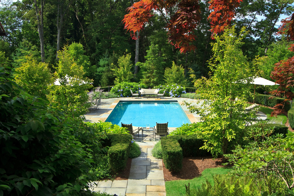 Design ideas for a traditional backyard garden for fall in Boston with natural stone pavers.