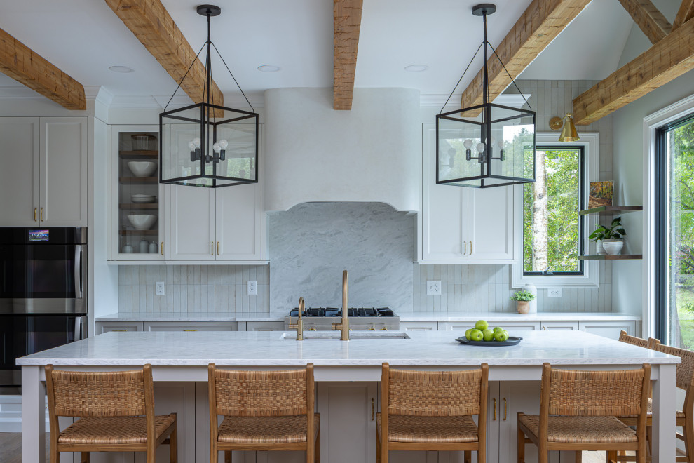 Open concept kitchen - large transitional medium tone wood floor and exposed beam open concept kitchen idea in Raleigh with an undermount sink, shaker cabinets, gray cabinets, quartz countertops, gray backsplash, porcelain backsplash, stainless steel appliances, an island and white countertops