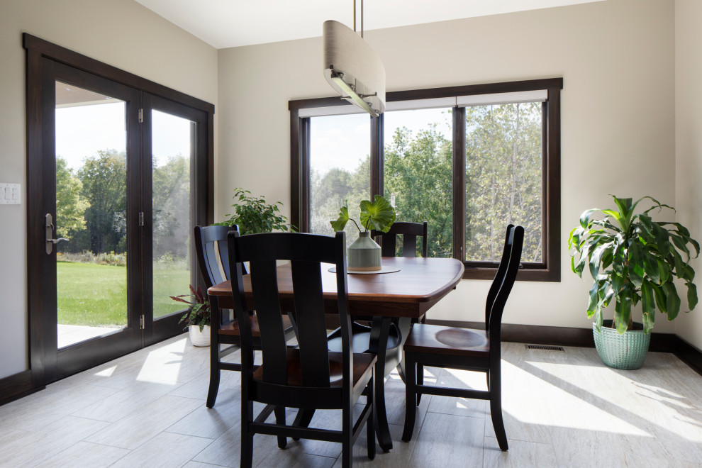This is an example of a mid-sized arts and crafts open plan dining in Milwaukee with grey walls, laminate floors, no fireplace and grey floor.