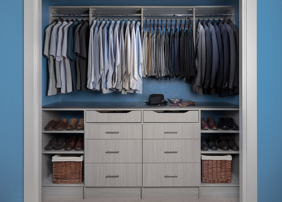 Photo of a mid-sized contemporary men's built-in wardrobe in Boston with flat-panel cabinets, grey cabinets and dark hardwood floors.