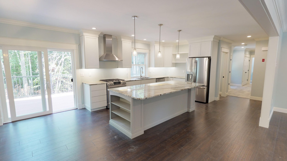 Open concept kitchen - mid-sized transitional l-shaped vinyl floor and brown floor open concept kitchen idea with an undermount sink, flat-panel cabinets, white cabinets, quartzite countertops, green backsplash, stainless steel appliances, an island and white countertops