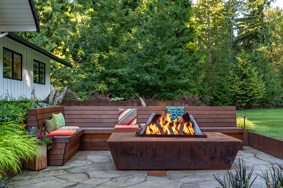 Inspiration for a small midcentury front yard patio in Seattle with a fire feature, natural stone pavers and no cover.