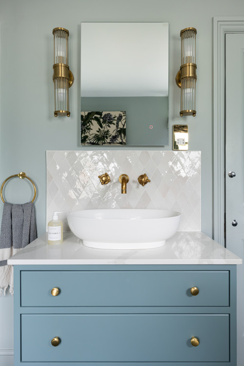 Diamond Tile Backsplash with Blue Vanity and Tube-Shaped Lighting Fixtures