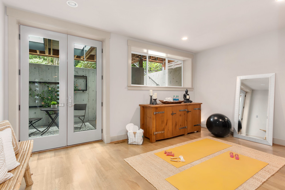 Home yoga studio - mid-sized modern light wood floor home yoga studio idea in Seattle with gray walls