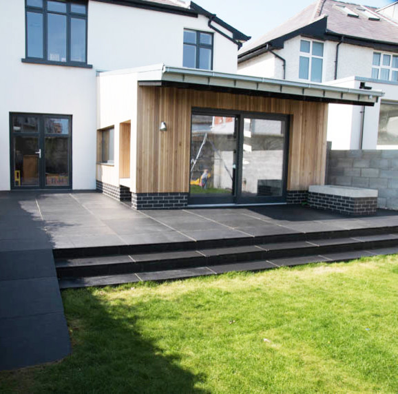 Photo of a mid-sized contemporary two-storey exterior in Dublin with wood siding.