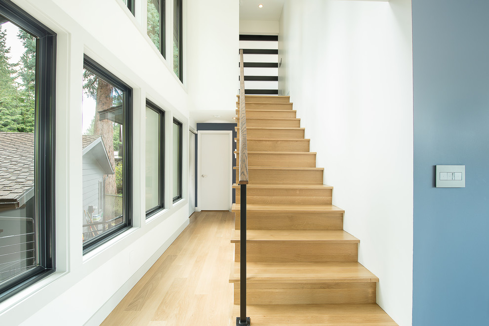 Inspiration for a mid-sized transitional wooden straight metal railing staircase remodel in Seattle with wooden risers