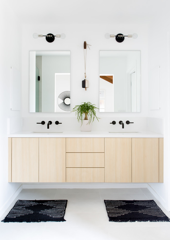 Mid-sized scandinavian master wet room bathroom in Los Angeles with flat-panel cabinets, light wood cabinets, white tile, white walls, ceramic floors, an undermount sink, engineered quartz benchtops, white floor, a freestanding tub and a hinged shower door.
