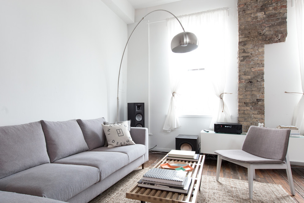 Inspiration for a scandinavian open concept living room in Chicago with white walls, medium hardwood floors and no fireplace.