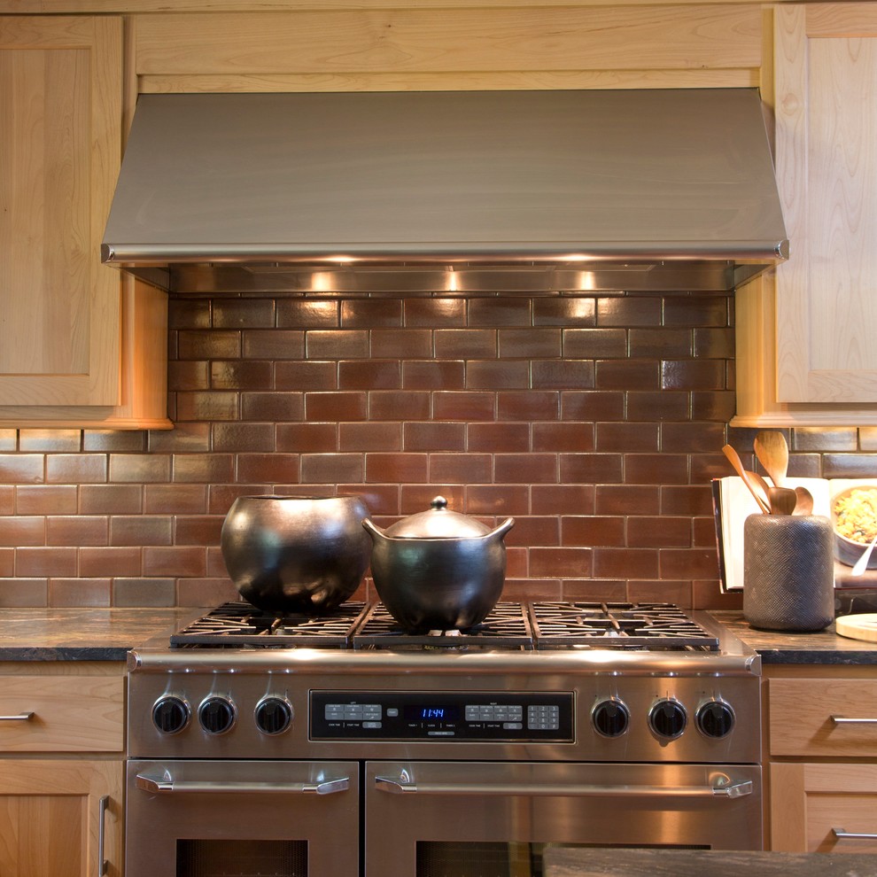 Example of a transitional kitchen design in Indianapolis with light wood cabinets, brown backsplash, subway tile backsplash and stainless steel appliances