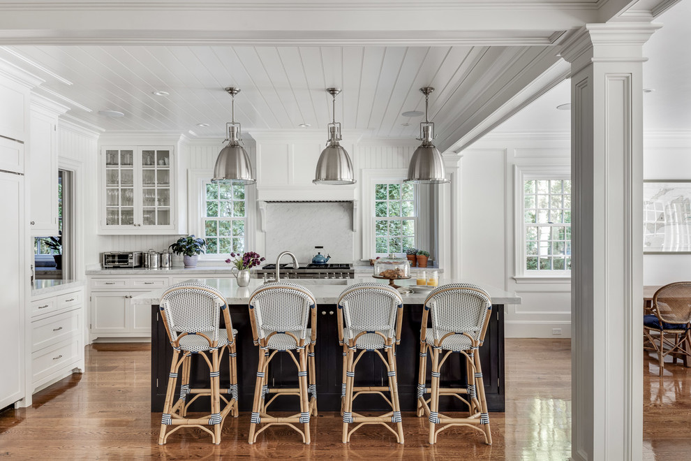 Design ideas for a mid-sized traditional eat-in kitchen in Boston with white cabinets, marble benchtops, white splashback, marble splashback, panelled appliances, medium hardwood floors, with island, white benchtop, a single-bowl sink and glass-front cabinets.