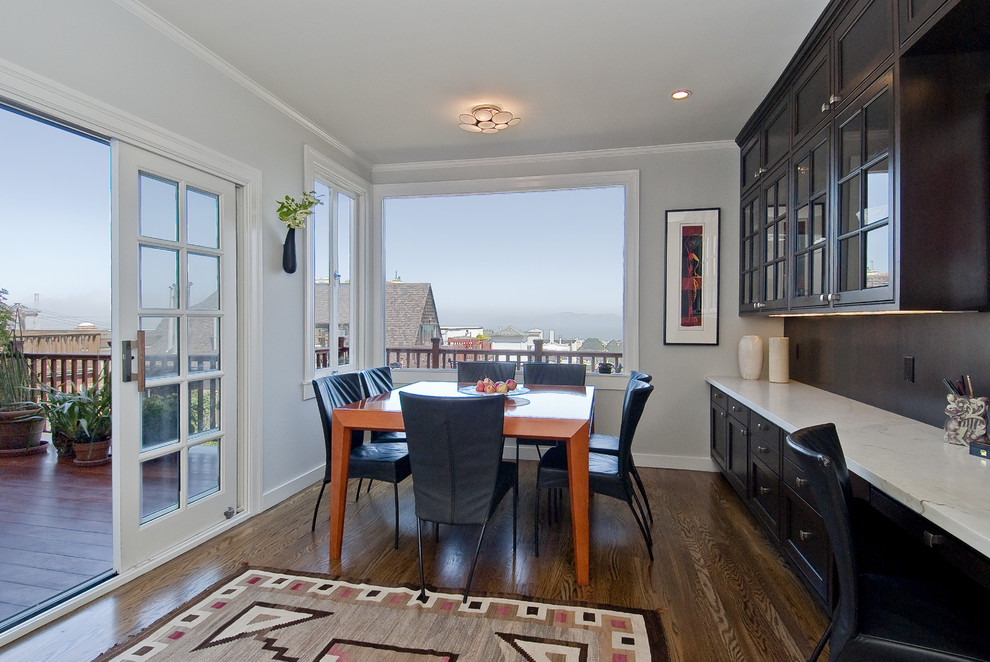 Contemporary dining room in San Francisco with grey walls and dark hardwood floors.