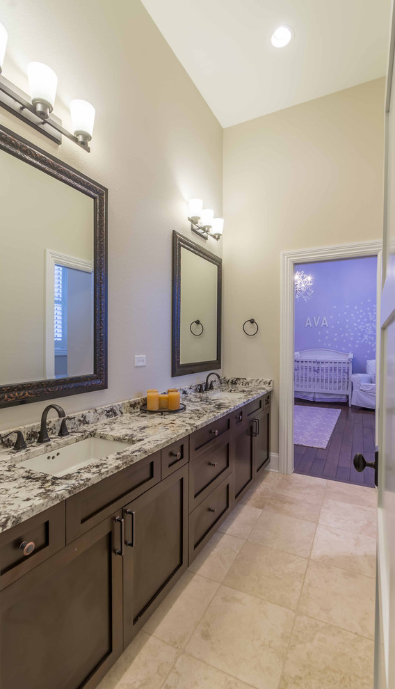 Photo of a mid-sized transitional kids bathroom in Chicago with recessed-panel cabinets, dark wood cabinets, an undermount tub, a shower/bathtub combo, a one-piece toilet, beige tile, limestone, beige walls, limestone floors, an undermount sink, engineered quartz benchtops, beige floor, a shower curtain, coffered, wallpaper, purple benchtops, a single vanity and a built-in vanity.