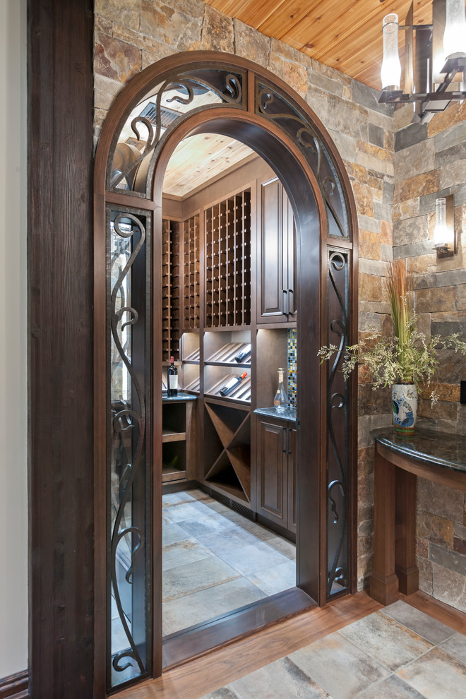 Photo of a mid-sized country wine cellar in Calgary with porcelain floors, display racks and multi-coloured floor.