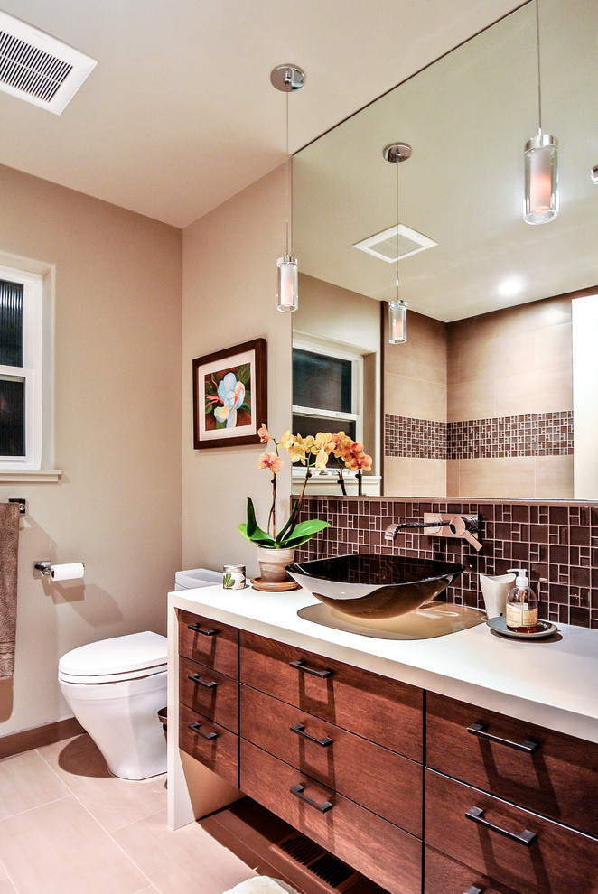 This is an example of a mid-sized arts and crafts master bathroom in San Francisco with flat-panel cabinets, white cabinets, a corner shower, brown tile, mosaic tile, grey walls, ceramic floors and solid surface benchtops.