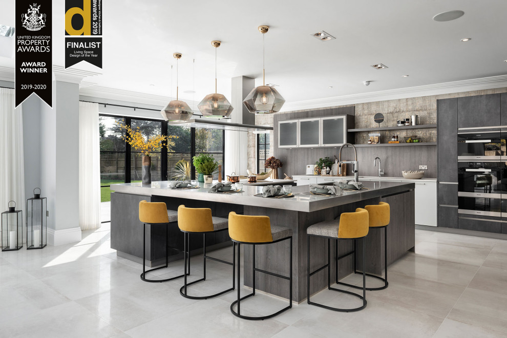 Photo of a large contemporary u-shaped open plan kitchen with flat-panel cabinets, grey cabinets and with island.