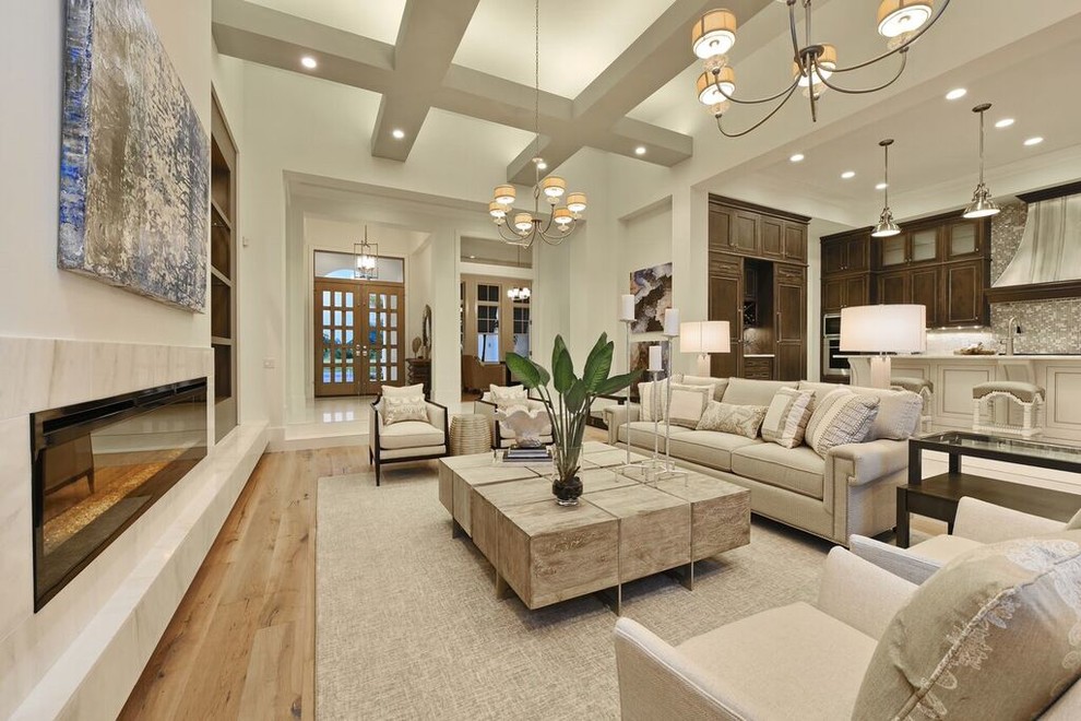 This is an example of a large contemporary open concept family room in Tampa with beige walls, medium hardwood floors, a ribbon fireplace, a stone fireplace surround and brown floor.