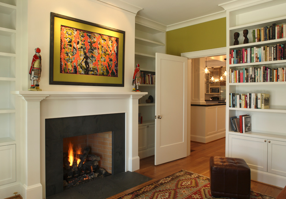 Large transitional home office in Portland with a library, green walls, dark hardwood floors, a standard fireplace and a tile fireplace surround.