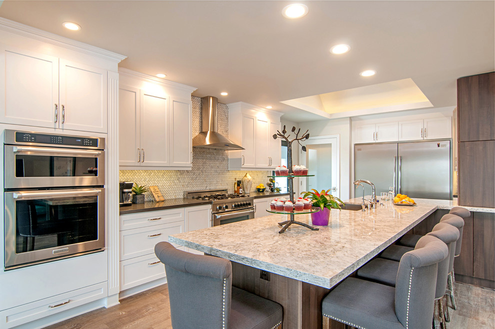 Transitional kitchen in San Diego with an undermount sink, white cabinets, quartz benchtops, mosaic tile splashback, stainless steel appliances, linoleum floors and with island.