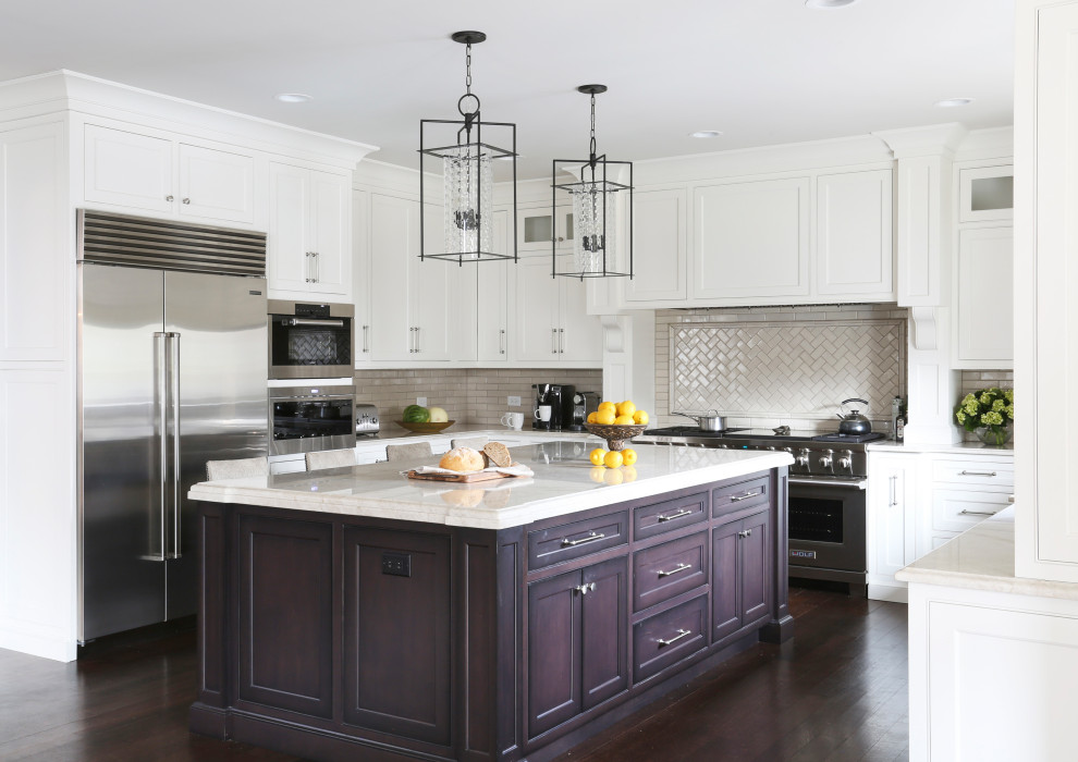 Inspiration for a large transitional u-shaped dark wood floor and brown floor open concept kitchen remodel in Chicago with an undermount sink, beaded inset cabinets, white cabinets, quartzite countertops, beige backsplash, ceramic backsplash, stainless steel appliances, an island and beige countertops