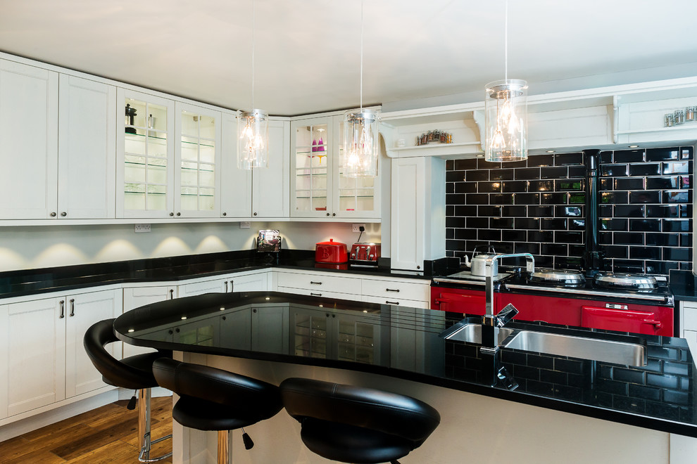 This is an example of a country kitchen in Cheshire with with island.