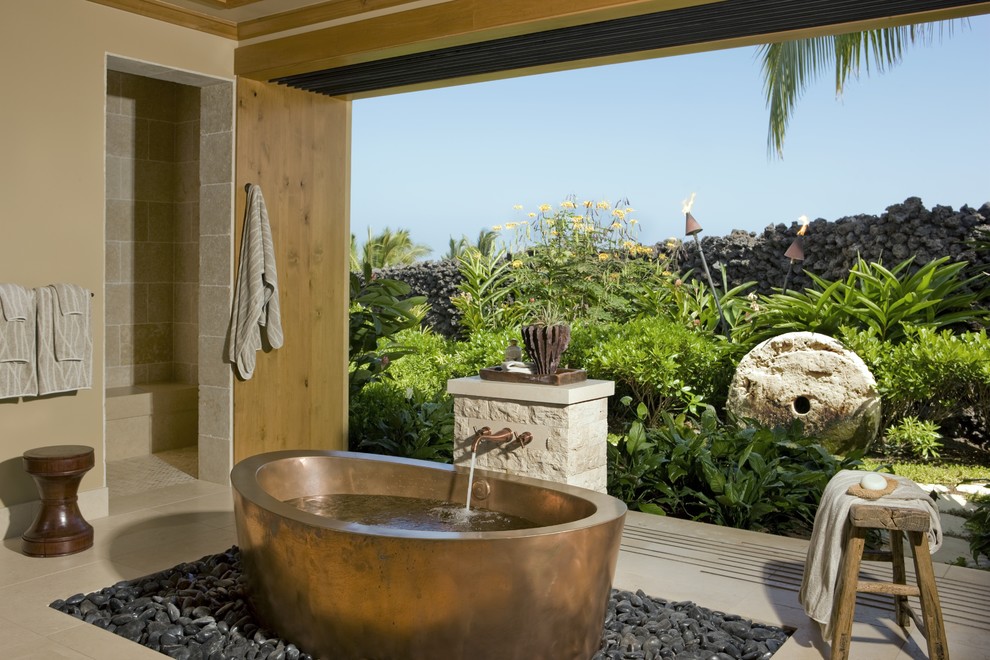Tropical bathroom in Hawaii with a freestanding tub.