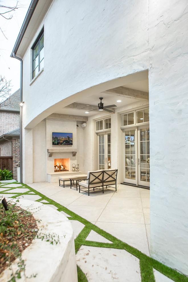 Large transitional backyard patio in Dallas with a fire feature, natural stone pavers and a roof extension.