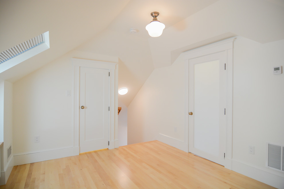 Inspiration for a mid-sized transitional master medium tone wood floor bedroom remodel in Boston with white walls