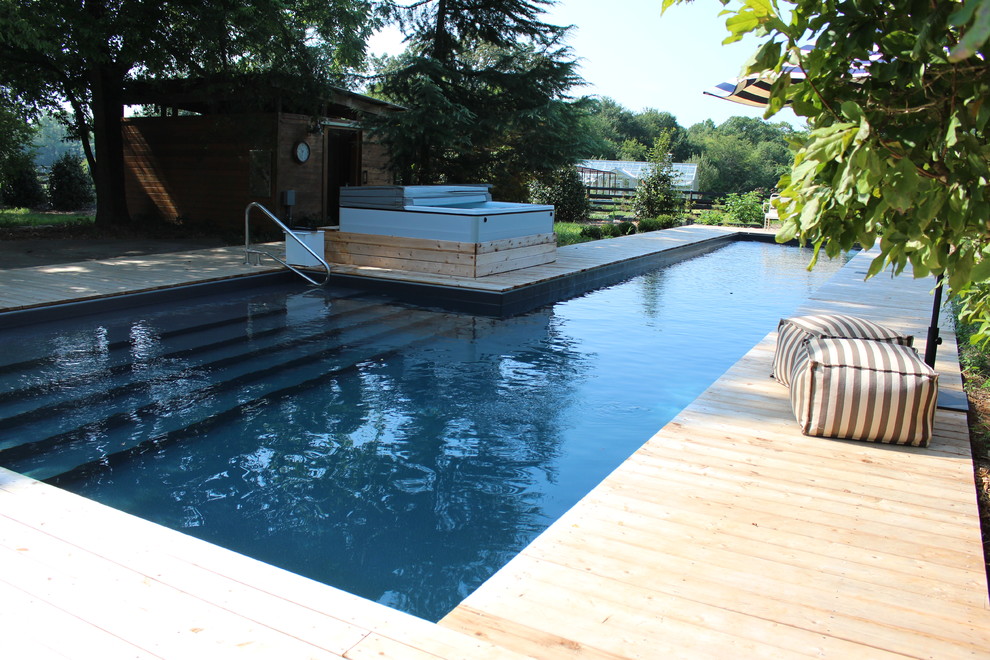 Photo of a large country backyard l-shaped natural pool in Atlanta with a hot tub and decking.