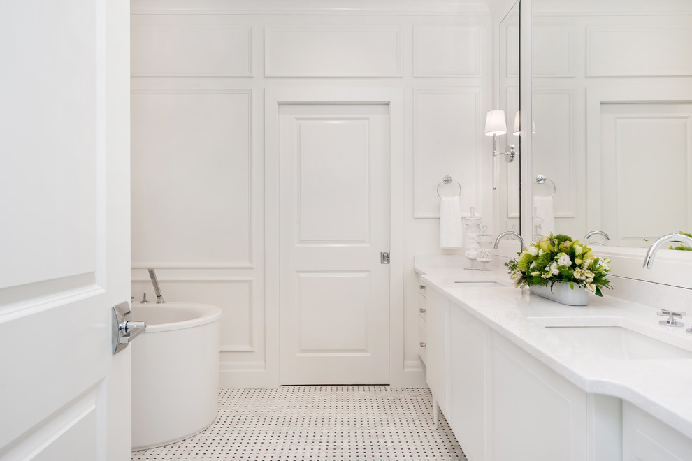 Inspiration for a large transitional master multicolored tile and mosaic tile mosaic tile floor freestanding bathtub remodel in Calgary with an undermount sink, raised-panel cabinets, white cabinets, quartz countertops, a one-piece toilet and white walls