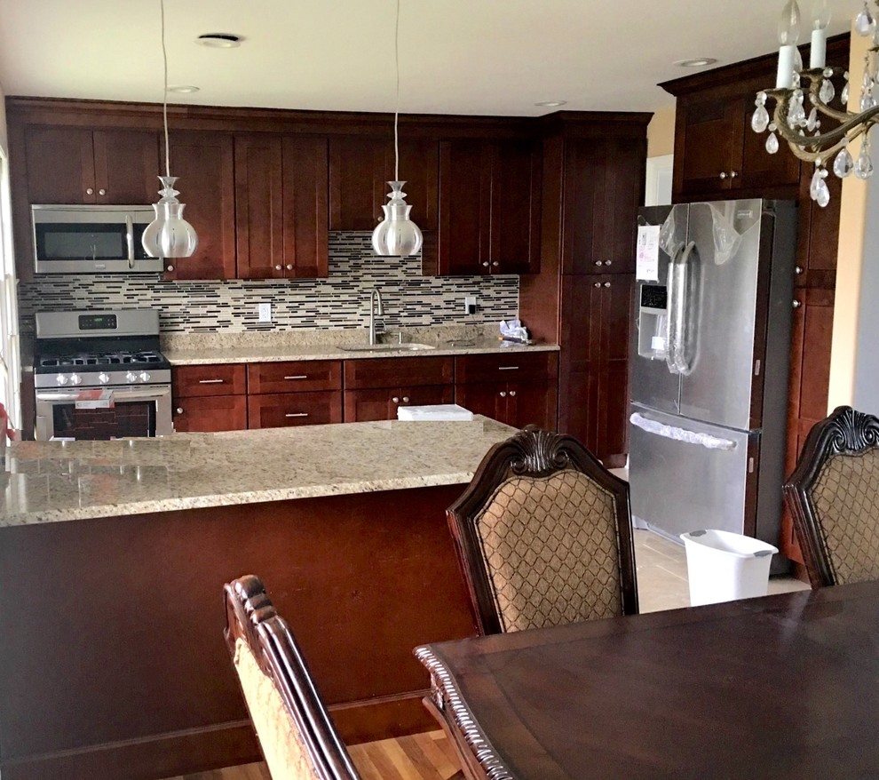 Inspiration for a mid-sized transitional single-wall eat-in kitchen remodel in New York with shaker cabinets, red cabinets, granite countertops, multicolored backsplash, mosaic tile backsplash, stainless steel appliances and an island