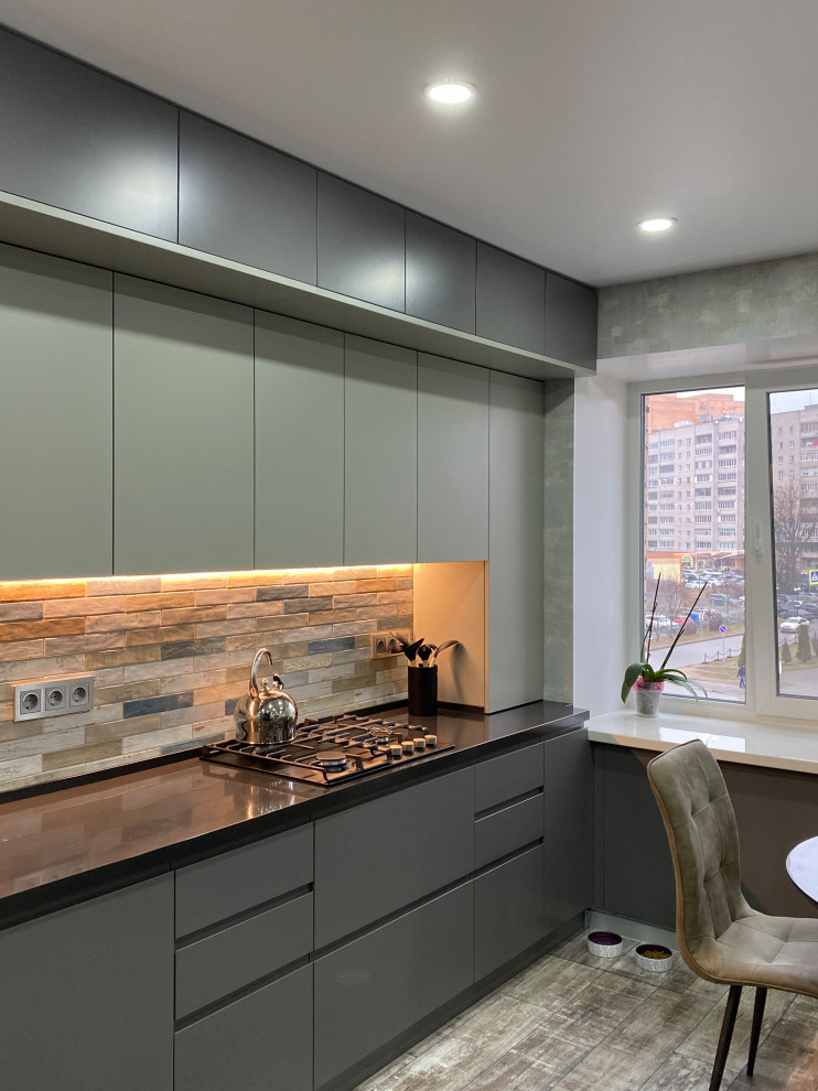 Eat-in kitchen - mid-sized contemporary single-wall eat-in kitchen idea in Moscow with flat-panel cabinets, gray cabinets, laminate countertops, no island and black countertops