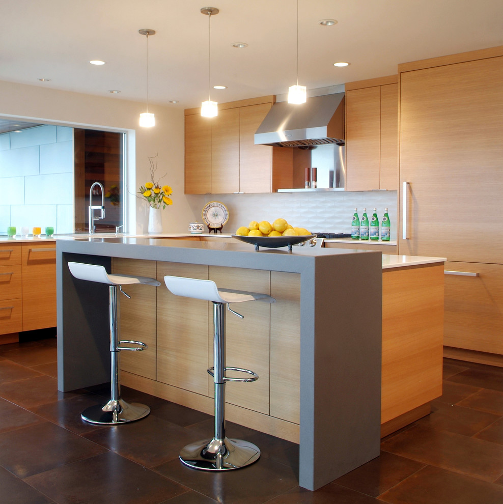 Inspiration for a contemporary l-shaped kitchen in Seattle with flat-panel cabinets, medium wood cabinets, white splashback, panelled appliances, with island and brown floor.