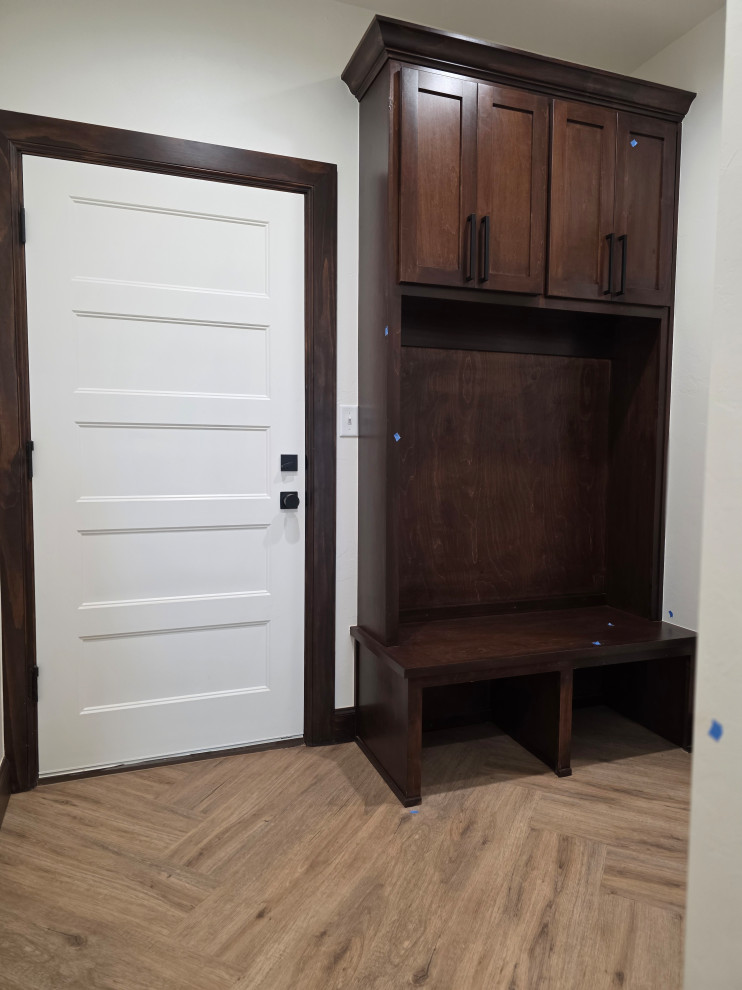 The custom built hall storage & bench sit off the garage entrance