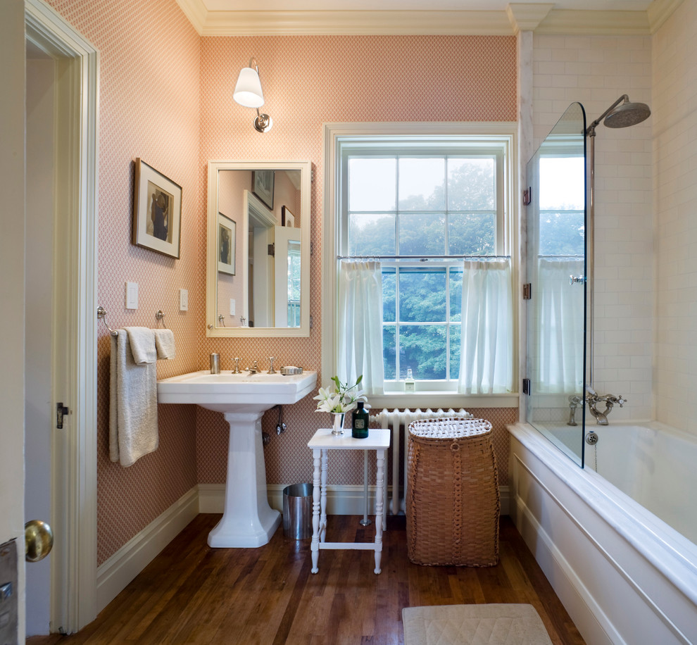 This is an example of a traditional bathroom in Other with a pedestal sink, an alcove tub and a shower/bathtub combo.