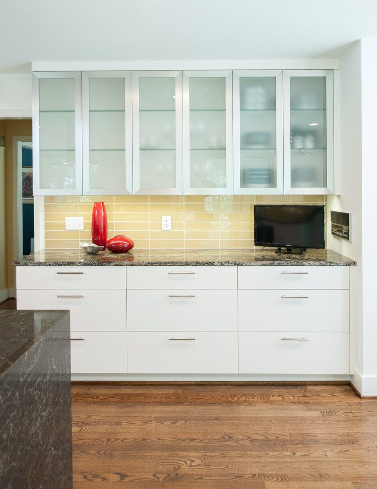 Design ideas for a mid-sized modern l-shaped separate kitchen in Kansas City with flat-panel cabinets, light wood cabinets, granite benchtops, yellow splashback, glass tile splashback, stainless steel appliances, medium hardwood floors, with island and a double-bowl sink.