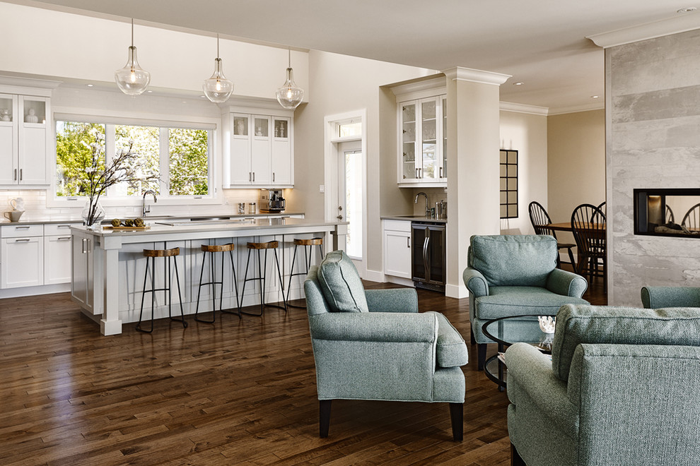 Inspiration for a large transitional u-shaped medium tone wood floor open concept kitchen remodel with an undermount sink, shaker cabinets, white cabinets, quartz countertops, white backsplash, subway tile backsplash, stainless steel appliances and an island